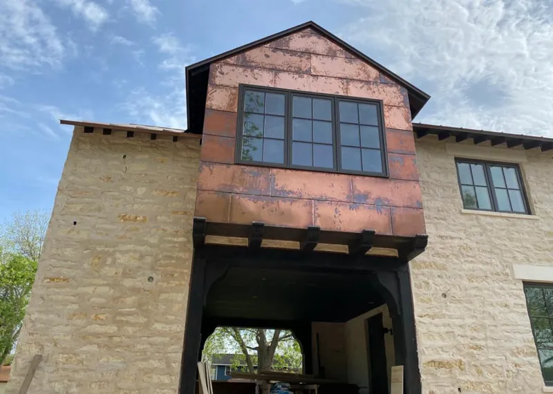 Copper metal panel facade on a stone building for Roof Repair in Cedar City
