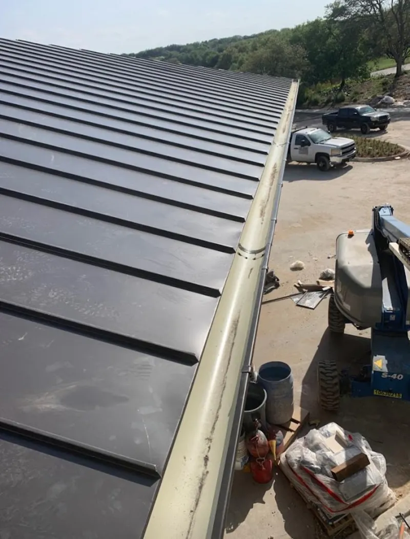 Standing seam panel and gutter detail on a metal roofing jobsite in Cedar City